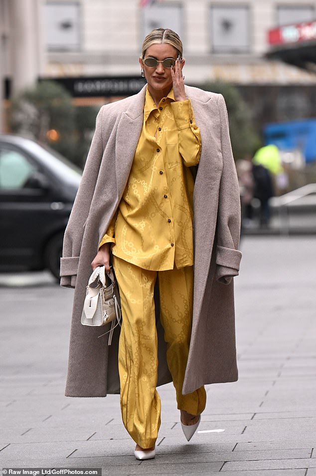 The former Pussycat Doll wore an overly loud fashion choice as she donned a pajama-like co-ord set and an oversized beige trench coat