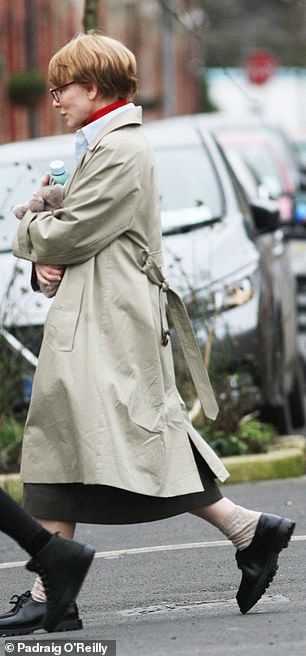 On Friday, the 54-year-old actress wore a sand-colored trench coat, over a light blue shirt and over a red turtleneck in the Irish capital.