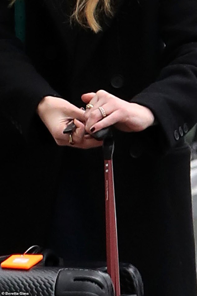 The ring on her engagement finger was visible as she got out of a car