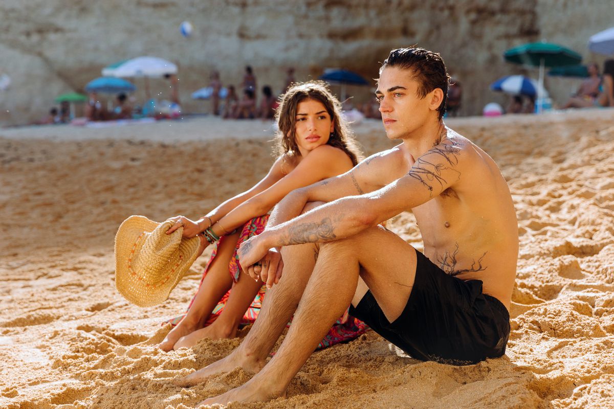 (L-R) Mimi Keene and Hero Fiennes Tiffin sit on a beach in After Everything.