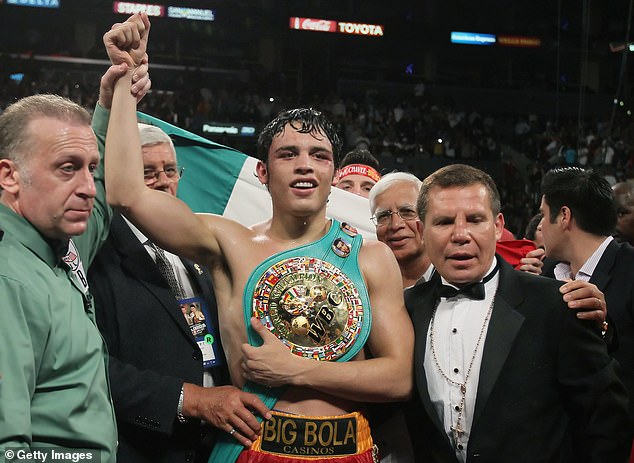 Julio Cesar Chavez Jr.  and his father (right) are seen after his victory over Sebastian Zbik in 2011