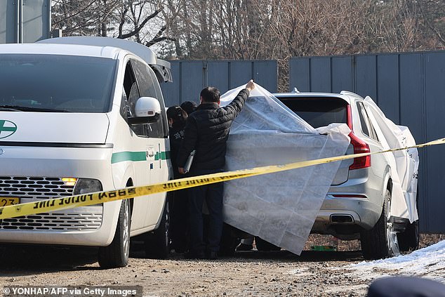 Police are seen guarding a vehicle believed to be where Lee committed suicide on Wednesday