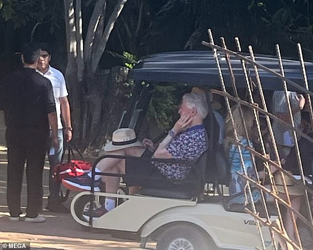 A relaxed-looking Bill Clinton, hat on his knee, is seen in a golf cart with the Newsoms at the Four Seasons in Tamarindo, Mexico