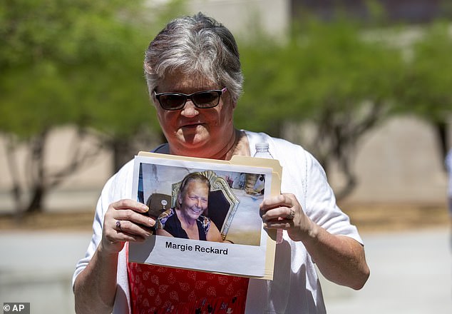 Hilda Reckard, daughter-in-law of El Paso Walmart shooting victim Margie Reckard, holds a photo of her relative outside federal court in El Paso, Texas, on July 7.