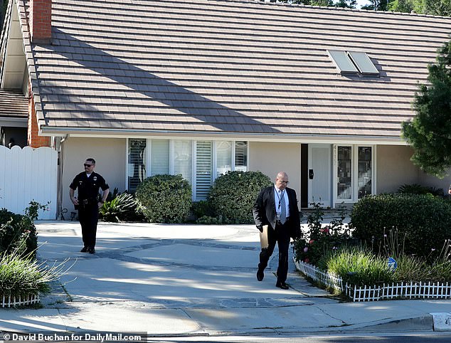 LAPD officers are seen at the Haskell home in Tarzana in November as the search continued for more bodies.  They also went to his office in Encino