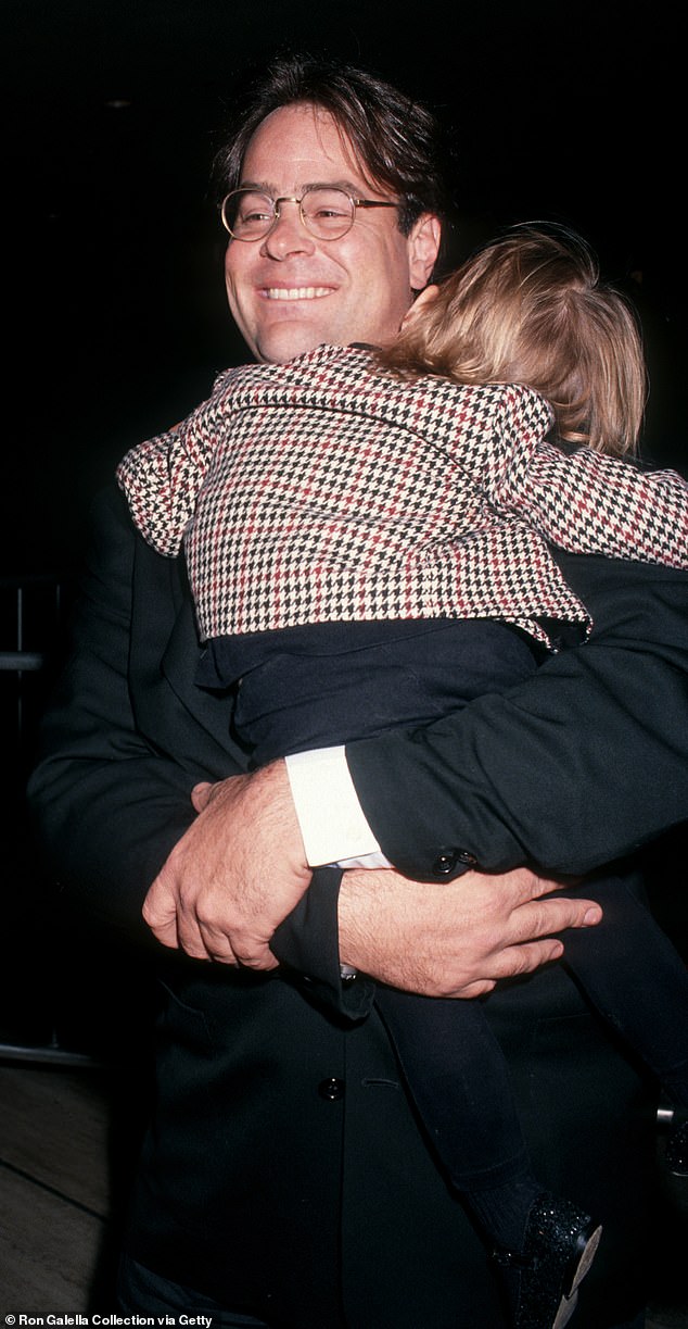 Dan and Donna, 66, welcomed Vera in 1989, when the Ghostbusters alum was at the height of his career.  She was seen in her father's arms in 1991