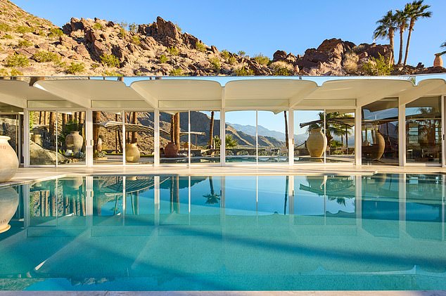 The Palm Springs mansion is complete with a giant rectangular pool for residents to dip into to cool off from the desert heat