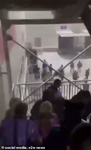 Employees frantically try to leave the building via the stairwell