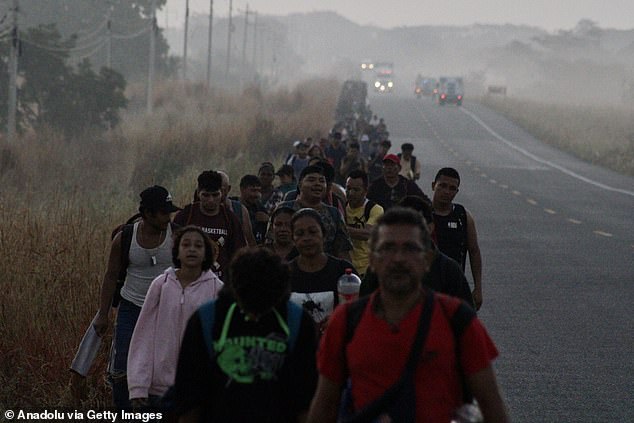 A group of migrants move with a migrant caravan heading to the U.S. border on the side of the highway in Oaxaca, Mexico on January 9