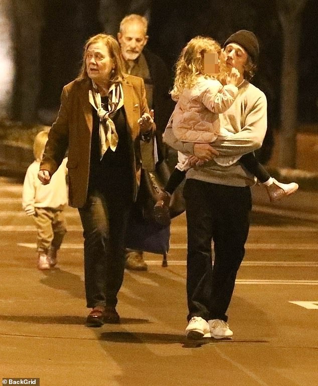 The Bear star, 32, carried his youngest daughter Ezer, three, while his eldest daughter Delores, five, walked with her grandparents Eloise Ziegler and Richard White as the group returned to their car.