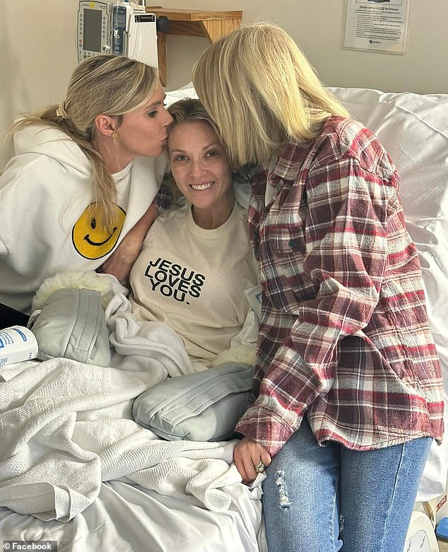 The 41-year-old nurse is pictured being kissed by her sister and girlfriend