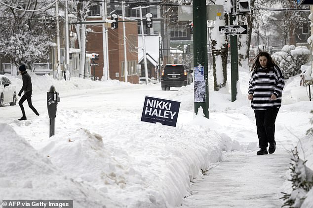 Snow surrounds Nikki Haley campaign signs in Iowa City ahead of her event