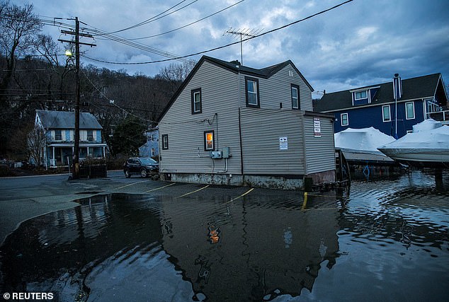 Water rises in a residential neighborhood in the aftermath of a storm in Piermont, New York, on Wednesday