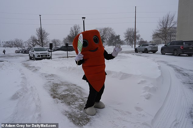 A person in a carrot suit braved the -1 degree weather with PETA to protest outside the DeSantis event in West Des Moines, Iowa, on Saturday.  They were turned away at the door