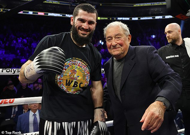 Beterbiev (pictured next to promoter Bob Arum) smiled after facing Smith