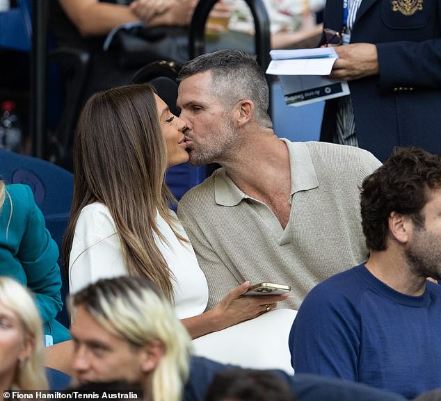 The former WAG and her husband locked lips during the game and shared a sweet kiss, oblivious to their surroundings