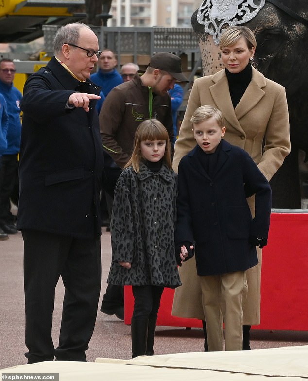 Charlene completed her look with black trousers and suede boots - and added some more glamor with diamond earrings