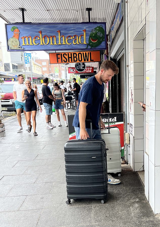 A man and a woman are seen arriving at their new home on Coogee's main strip