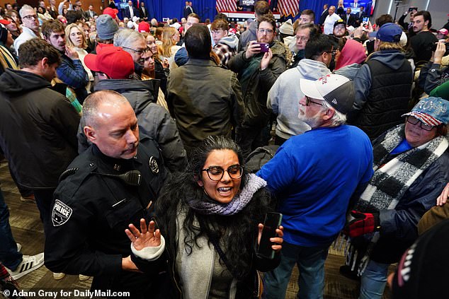 A protester was escorted from the room when her outburst interrupted Gov. Burgum's start of Donald Trump's endorsement