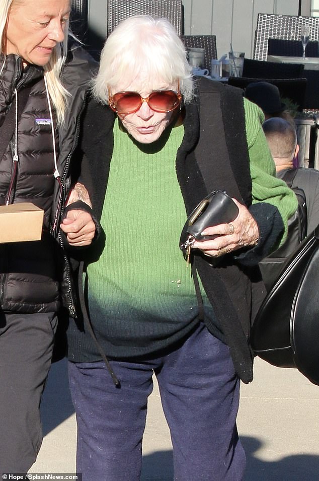 The Steel Magnolias actress wore a vibrant Kelly green sweater with navy blue pants and a black vest