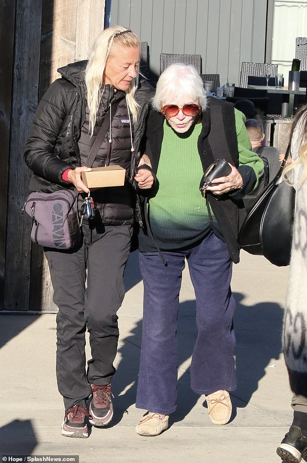 Her white hair looked amazing as it caught and reflected the sun's rays in the seaside resort