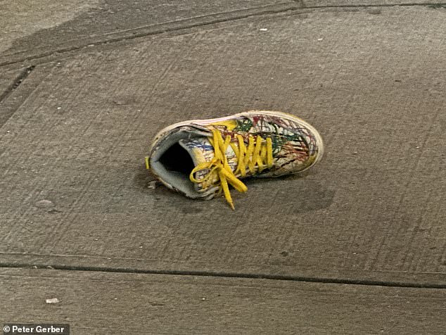 Luis Morales, Camilo's 80-year-old neighbor, painted a similar picture, describing how the late Starbucks manager was always loud when he saw her around the building.  Pictured: A single shoe lies on the sidewalk in the aftermath of the incident