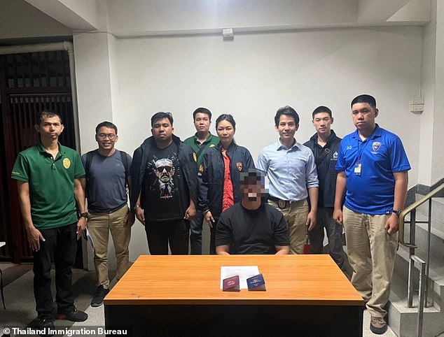 Rodrigo Elices (pictured sitting) was photographed surrounded by the immigration officers who arrested him, along with the two passports they allegedly found in his possession