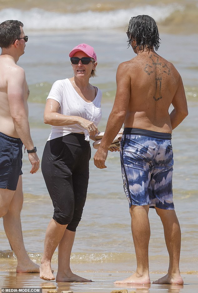 Rocky went shirtless and showed off his giant cross-body tattoo in blue and white Hurley beach shorts