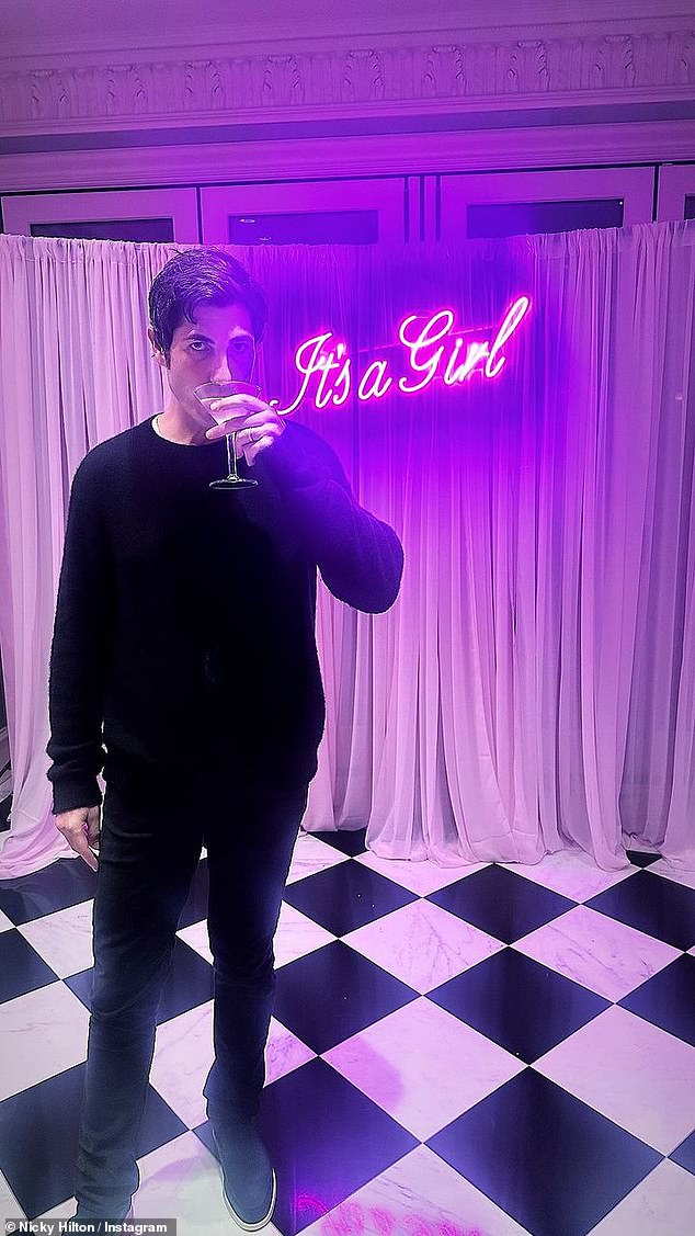 Davis also enjoyed a fruity pink drink in front of an LED sign that read: 'It's a girl'