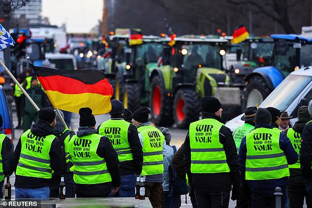 People wear safety vests with the text 'we are the people'