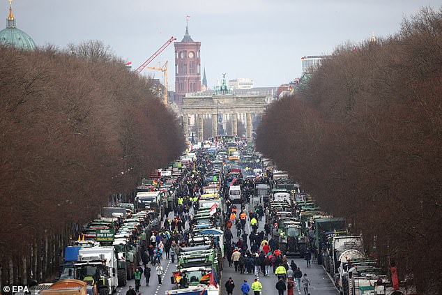 Farmers stand with their vehicles in front of the Brandenburg Gate during a nationwide farmers' strike in Berlin on January 15