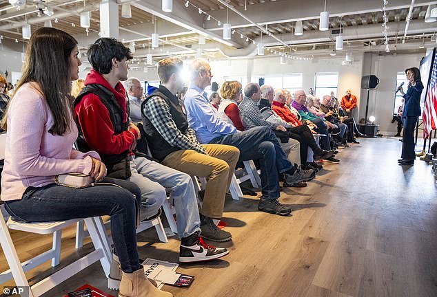 Nikki Haley's two children Rena, 26, and Nalin, 22, sit far left and listen to their mother speak at Toast restaurant in Ankeny, Iowa, on Thursday, January 11