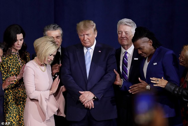 Pastor Paula White, left, and other faith leaders pray with President Donald Trump, center, during a rally for evangelical supporters at King Jesus International Ministry church, Friday, Jan. 3, 2020, in Miami