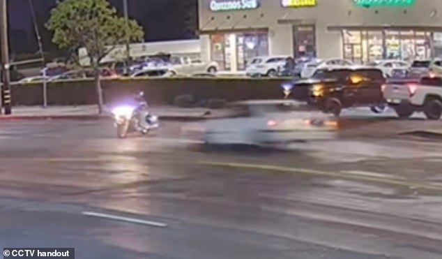 Surveillance footage captured a hit-and-run that occurred on November 9 when a white BMW sped toward a motorcyclist and killed him in Los Angeles.