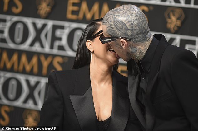 The duo, who matched in black suits and oversized sunglasses, looked as in love as ever as they looked at each other adoringly as photographers snapped their photo.