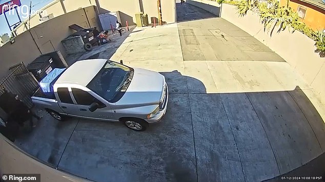 In the clip, captured by a Ring camera near a strip mall in National City on Friday morning, a man in a black hooded sweatshirt is seen taking his cart to a dumpster in a parking lot.