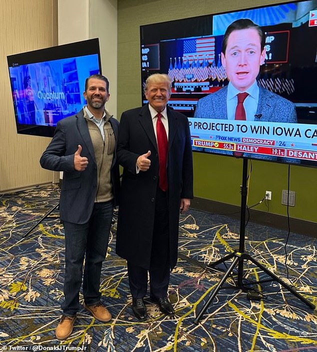 Trump posed with son Don Jr.  for a screen showing the results