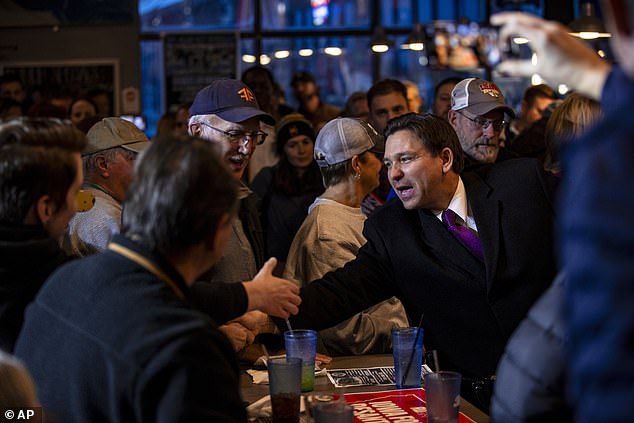 Ron DeSantis, vying for second place, greets supporters at Jerseys Pub and Grub in Cedar Rapids