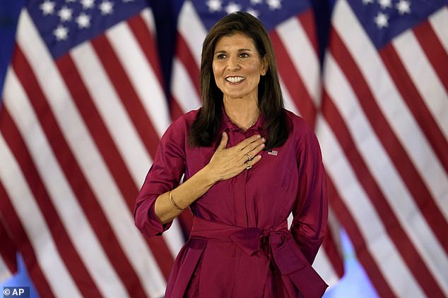 The former U.N. ambassador gestures to the audience as she concludes a speech at a caucus night party at the Marriott Hotel in West Des Moines, Iowa