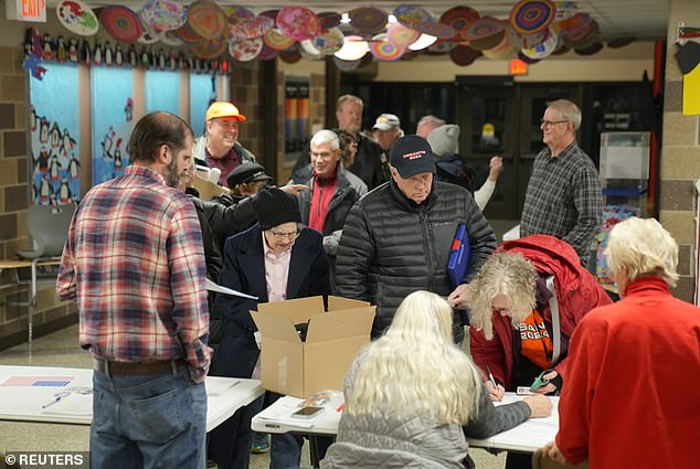Voters arrive at a caucus location at Fellows Elementary School to choose their Republican candidate