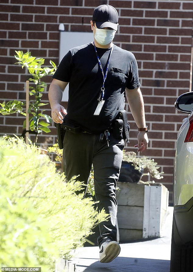 Officers were seen paying particular attention to a garage next to the house, transporting brown evidence bags from the room to a waiting vehicle.