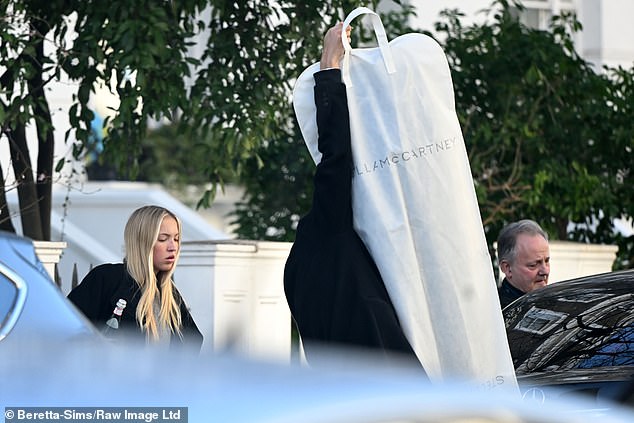 The 21-year-old model was spotted from her home in London carrying several bags and what appeared to be a very large Stella McCartney dress.