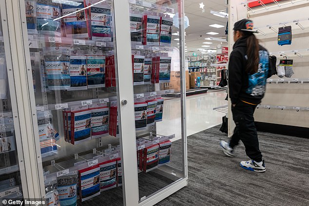 Products are locked behind glass as someone shops at a Target store in the Harlem neighborhood of Manhattan on September 28, 2023 in New York City.