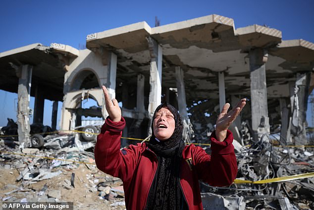 A Palestinian woman cries in front of a destroyed building in the Al-Maghazi refugee camp in central Gaza Strip, January 16