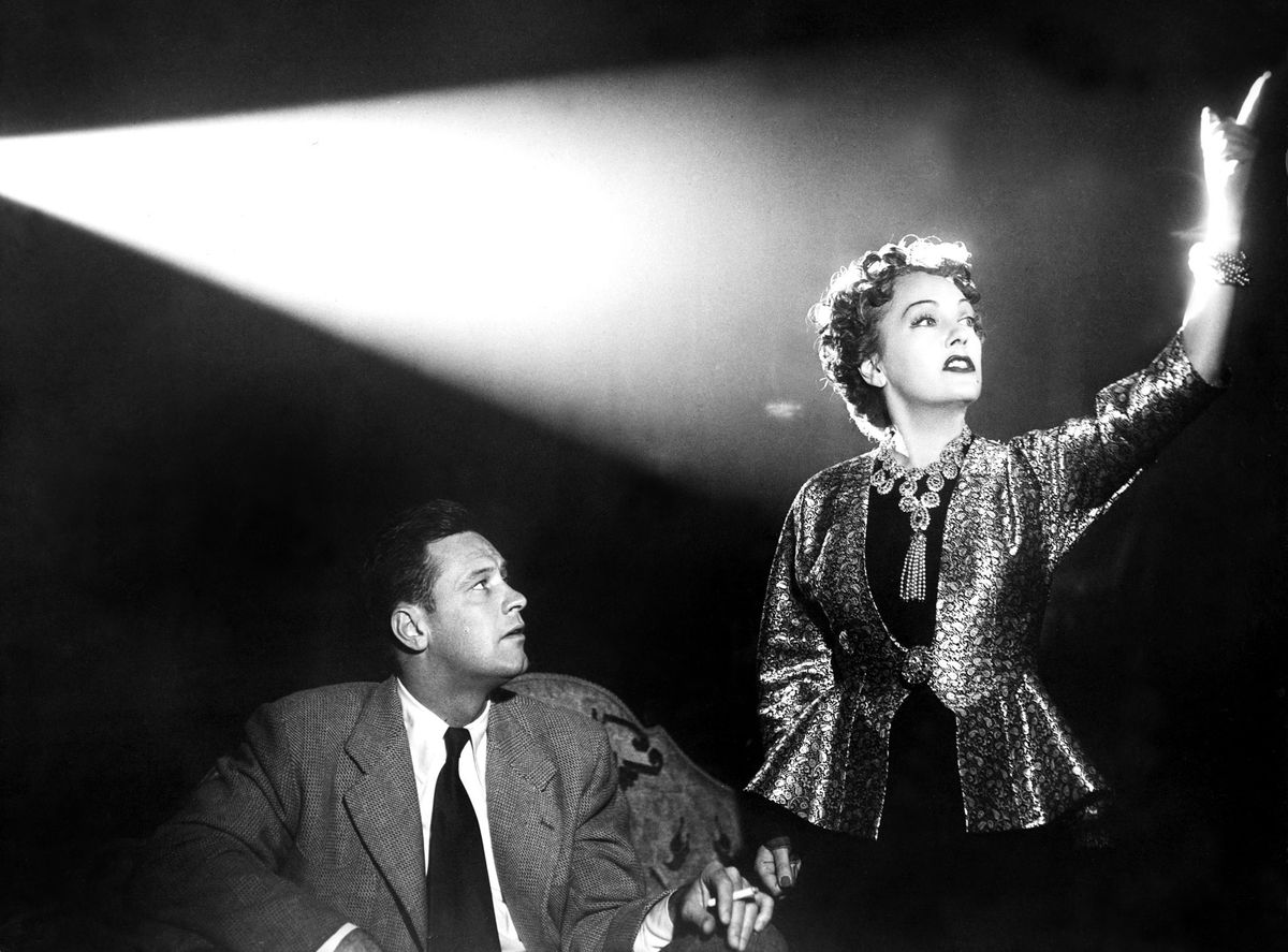 Norma Desmond (Gloria Swanson) stands up and yells at Joe Gillis (William Holden) as they watch a movie together in her screening room.  She's very distracting.