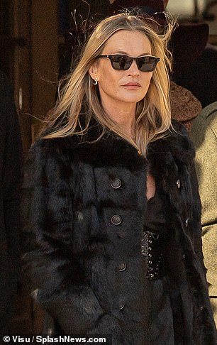 The supermodel paired the garment with a fur coat and enhanced her figure with a pair of suede heeled ankle boots