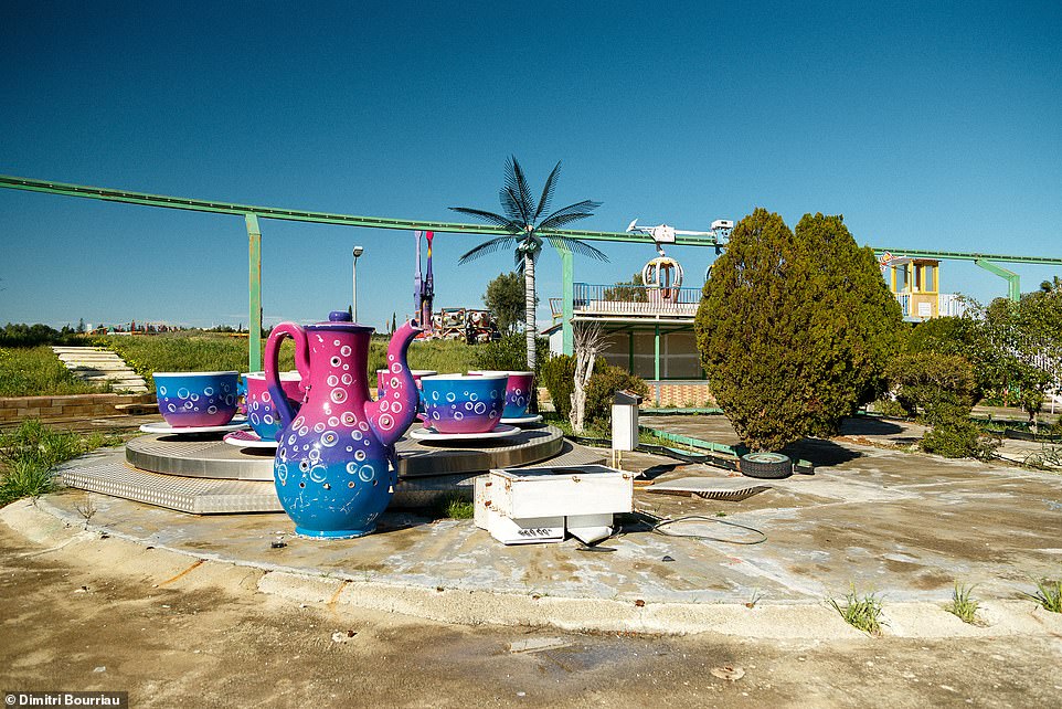 In this photo, a child's teacup ride lies in pieces on the ground