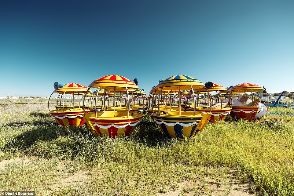 See the carriages of another fairground attraction in the park, which appears to have been taken apart and left to nature