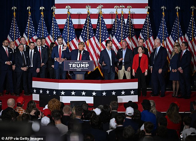 Trump delivered his victory speech flanked by family and campaign staff, including sons Eric (Trump's left) and Don Jr (right)