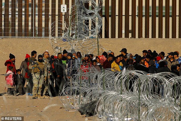 Migrants arrive at the US-Mexico border outside El Paso, Texas, awaiting entry into the US